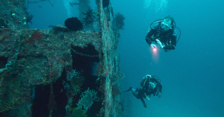 Divers diving on a wreck with Big Blue Vanuatu on a morning double dive
