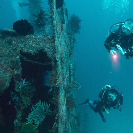 Divers diving on a wreck with Big Blue Vanuatu on a morning double dive